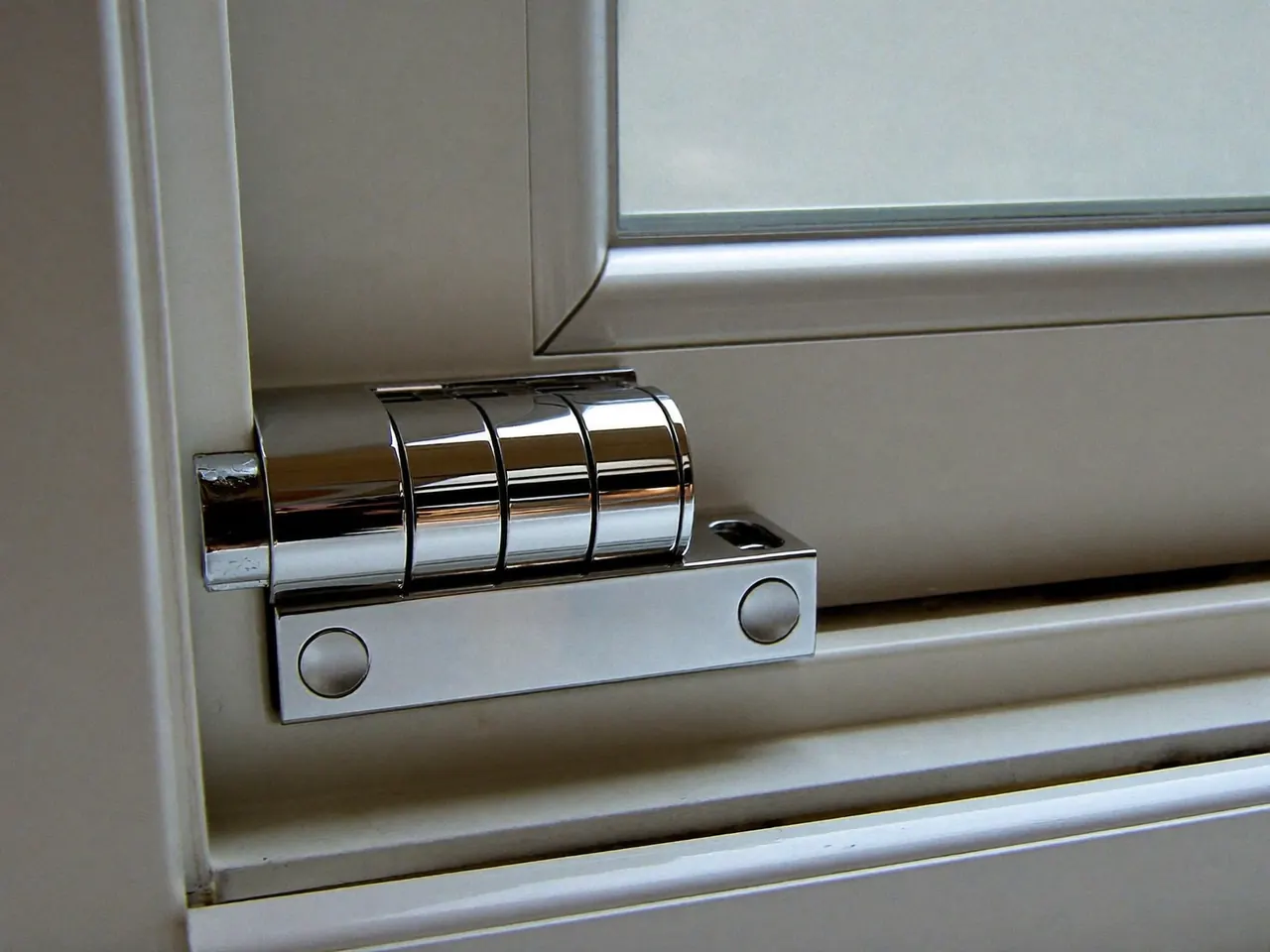 Close-up of a multi-point locking handle on a modern window